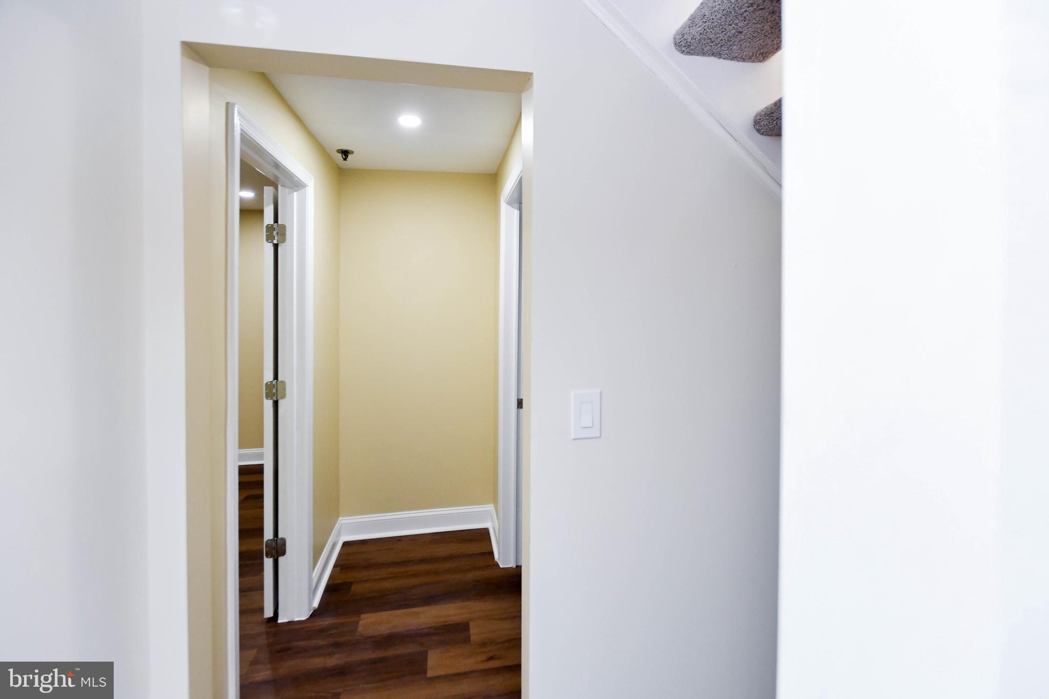 5908 Grenfell Loop Bowie, MD 20720 - Photo 10 of 65 a view of a hallway with wooden floor and entryway