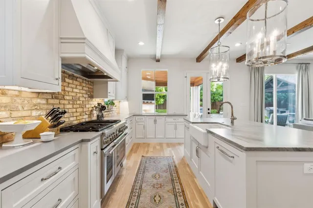 a kitchen with stainless steel appliances granite countertop a sink and a stove