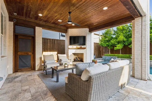 a living room with furniture a flat screen tv and a floor to ceiling window