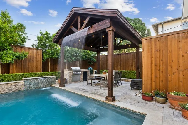 a view of a house with backyard and sitting area