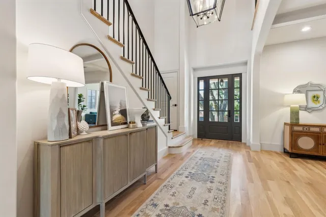 a view of a hallway with wooden floor and staircase