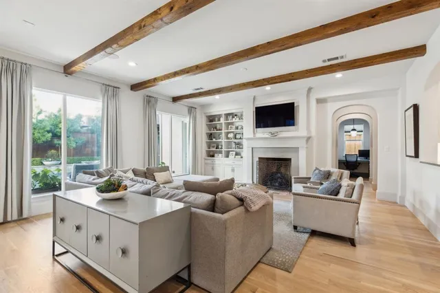 a living room with furniture fireplace and window