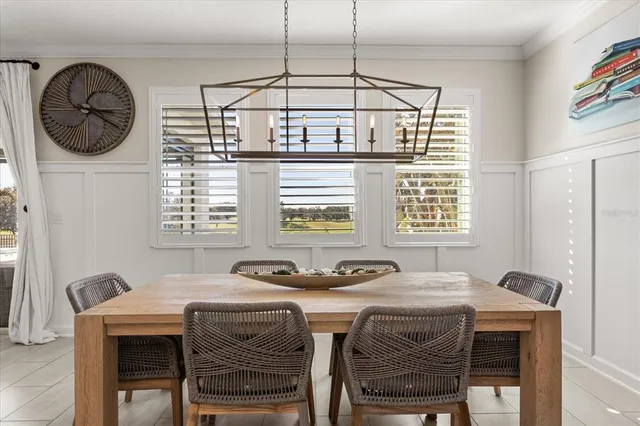 a view of a hallway to a livingroom with furniture and wooden floor
