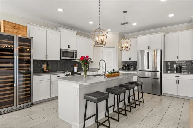 a large kitchen with stainless steel appliances kitchen island a stove a refrigerator and a sink
