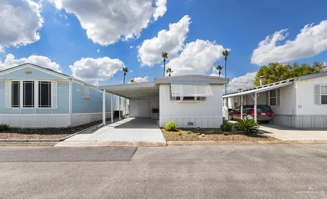 a view of a house with a yard and garage