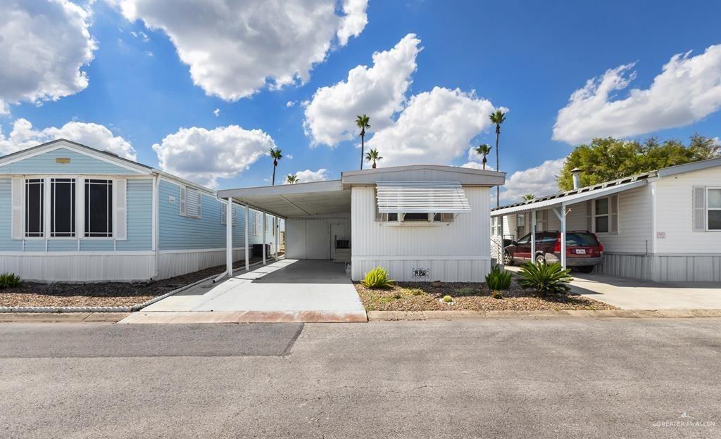 a view of a house with a yard and garage