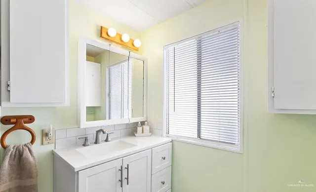 a bathroom with a sink and a mirror