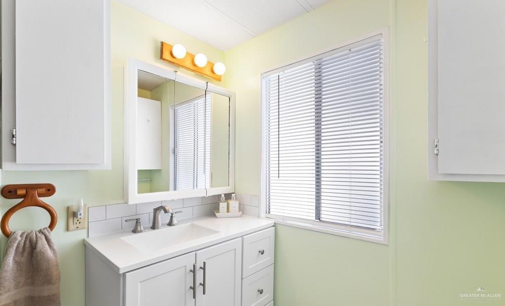 128 Apache Drive Harlingen, TX 78552 - Photo 9 of 17 a bathroom with a sink and a mirror