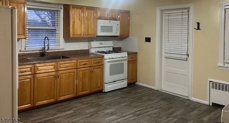 3 Freeman Place Nutley, NJ 07110 - Photo 2 of 10 a kitchen with stainless steel appliances granite countertop a sink stove and refrigerator