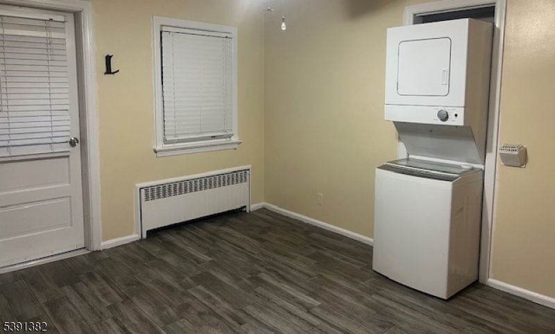 3 Freeman Place Nutley, NJ 07110 - Photo 3 of 10 an empty room with wooden floor and windows