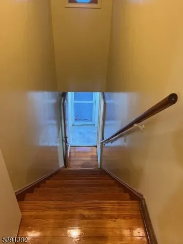 a view of a room with wooden floor