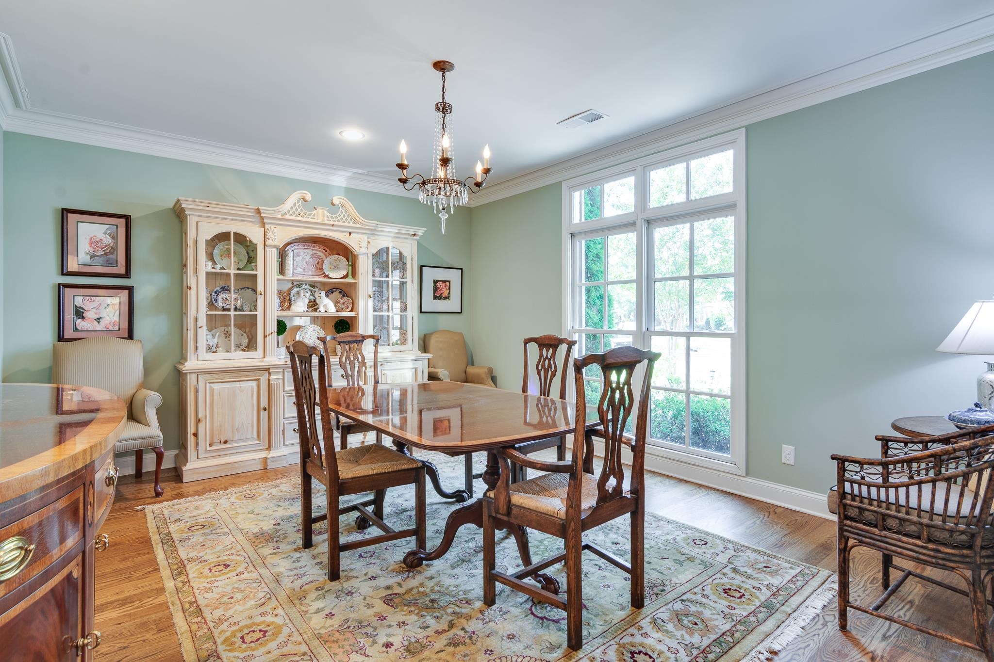 Dining room featuring crown molding, a chandelier, and light wood-style flooring