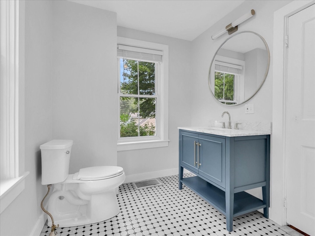 186 Main Street, Unit 2 Wayland, MA 01778 - Photo 14 of 41 a bathroom with a sink toilet and mirror