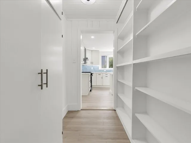 a view of a kitchen with wooden floor