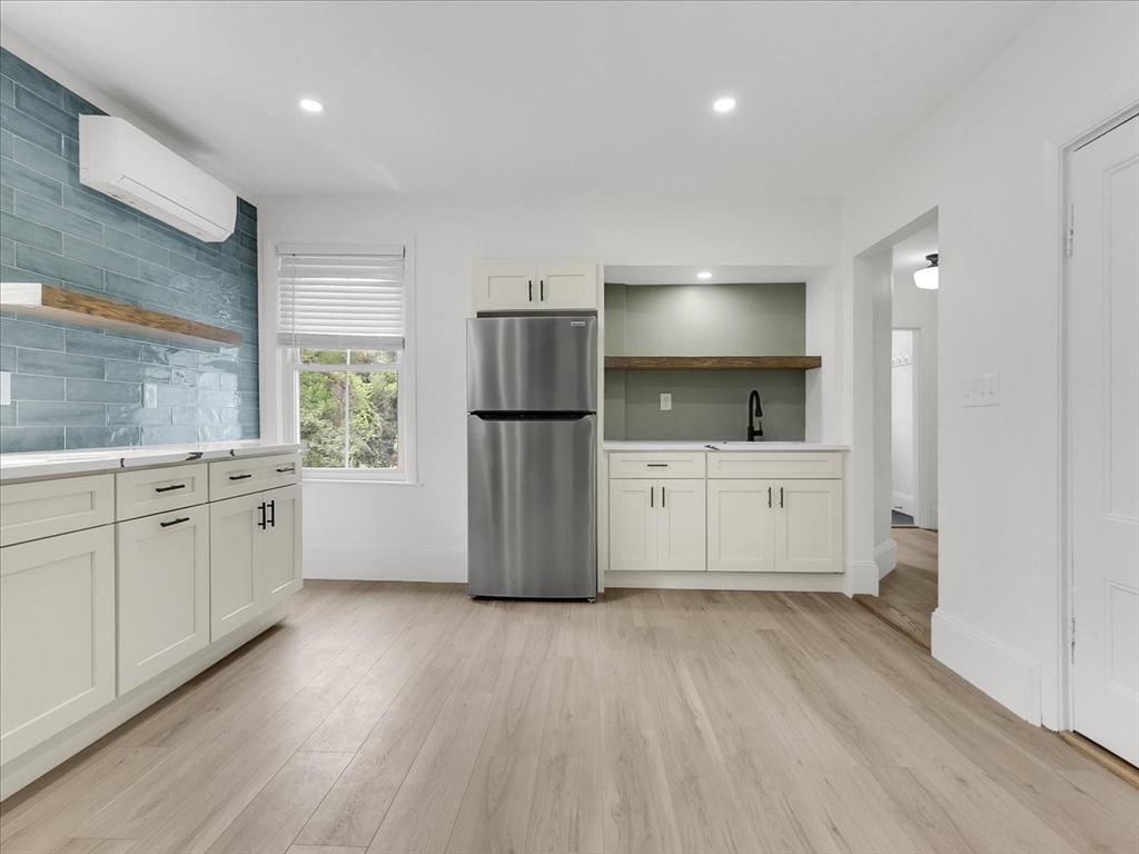 186 Main Street, Unit 2 Wayland, MA 01778 - Photo 24 of 41 a kitchen with a white cabinets and refrigerator
