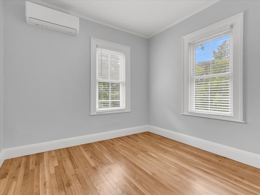186 Main Street, Unit 2 Wayland, MA 01778 - Photo 26 of 41 a view of an empty room with wooden floor and a window