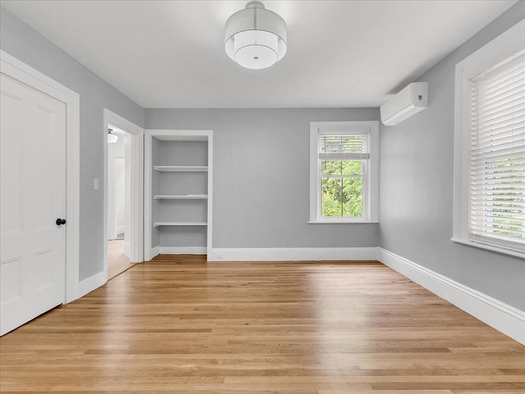 186 Main Street, Unit 2 Wayland, MA 01778 - Photo 31 of 41 an empty room with wooden floor closet and windows