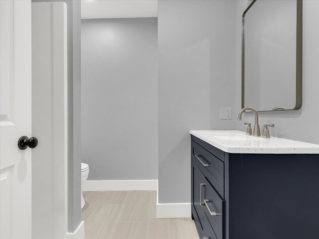 186 Main Street, Unit 2 Wayland, MA 01778 - Photo 38 of 41 a bathroom with a sink and a mirror