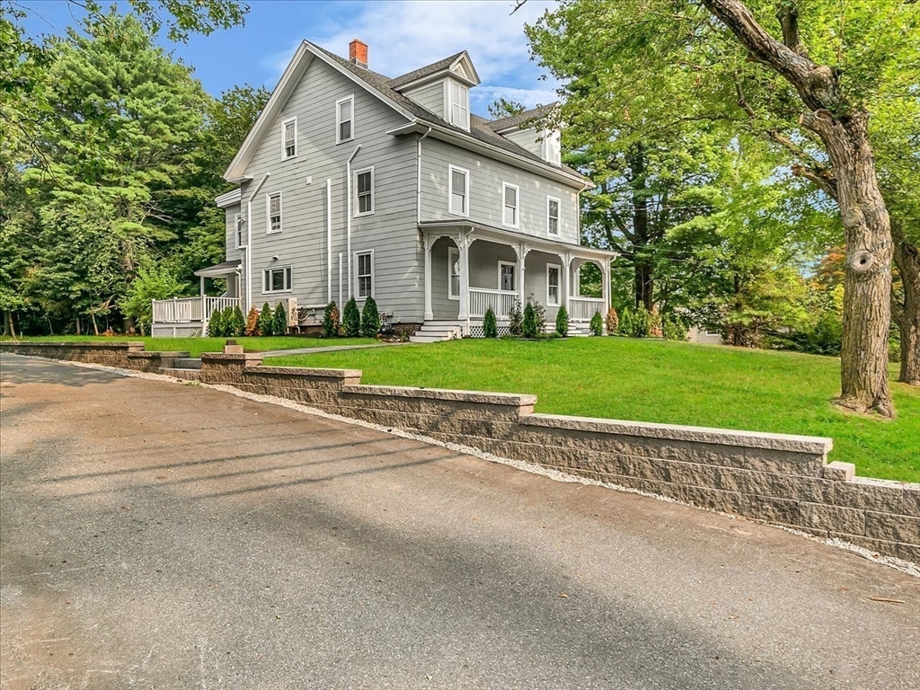 186 Main Street, Unit 2 Wayland, MA 01778 - Photo 39 of 41 a view of a white house with a yard and large trees