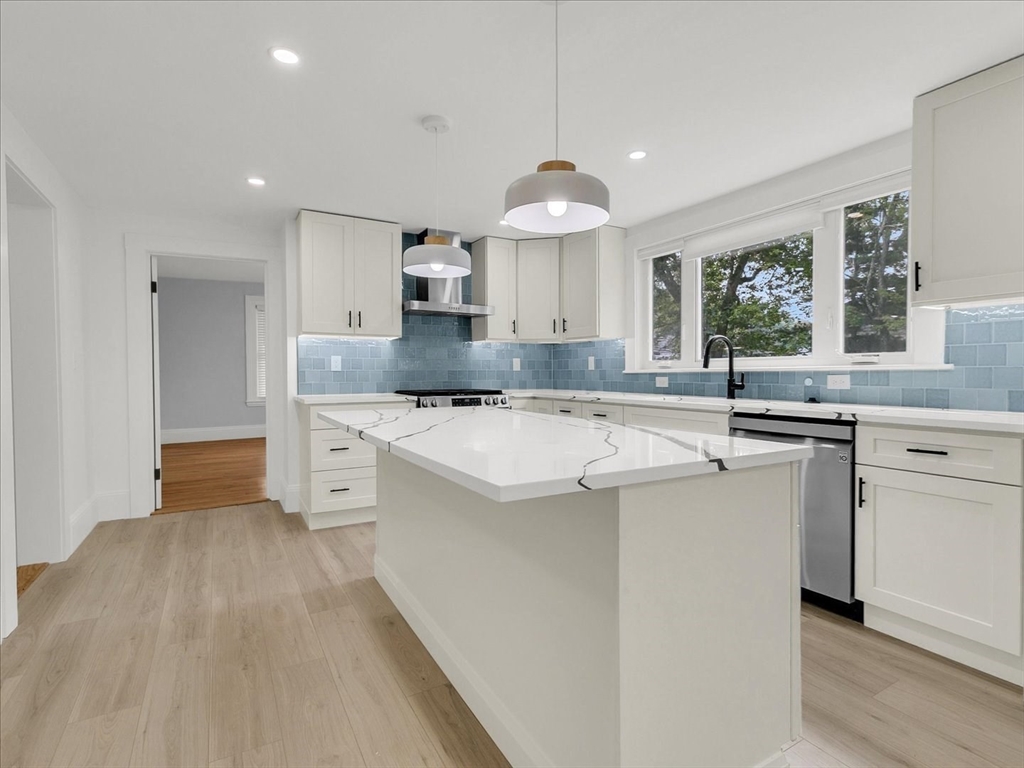186 Main Street, Unit 2 Wayland, MA 01778 - Photo 5 of 41 a kitchen with stainless steel appliances kitchen island granite countertop a sink and a stove