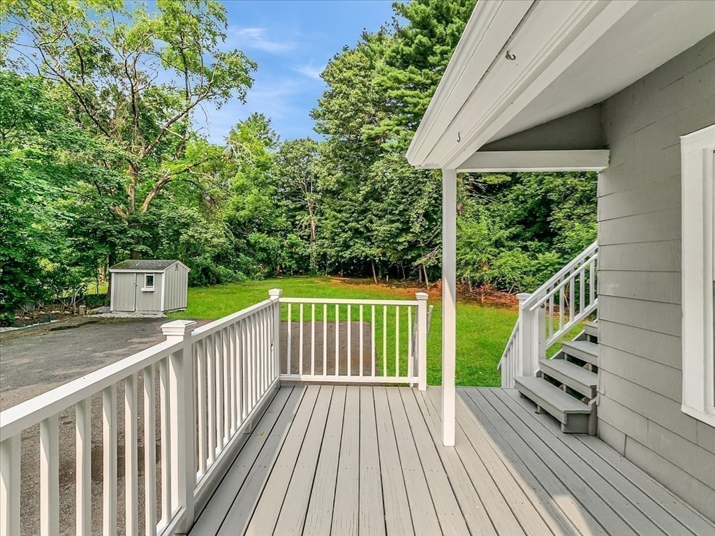 186 Main Street, Unit 2 Wayland, MA 01778 - Photo 9 of 41 a view of balcony with wooden floor and fence