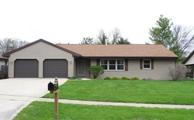 a front view of house with a garden