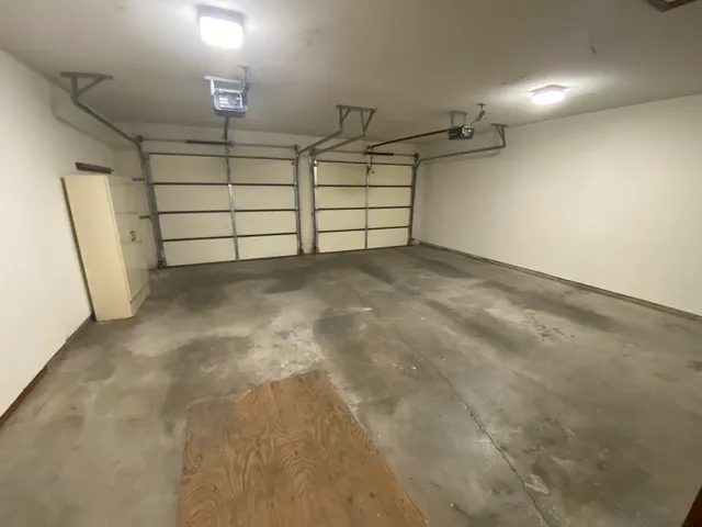 a view of a yard with wooden fence