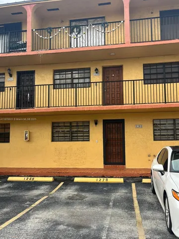 a front view of a house with parking space