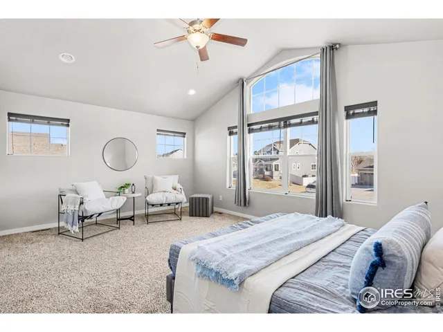 a bedroom with a bed mirror and window