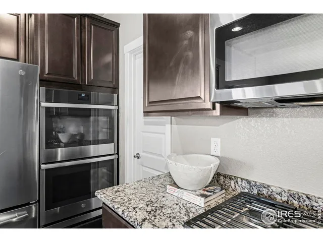 a kitchen with a refrigerator and cabinets