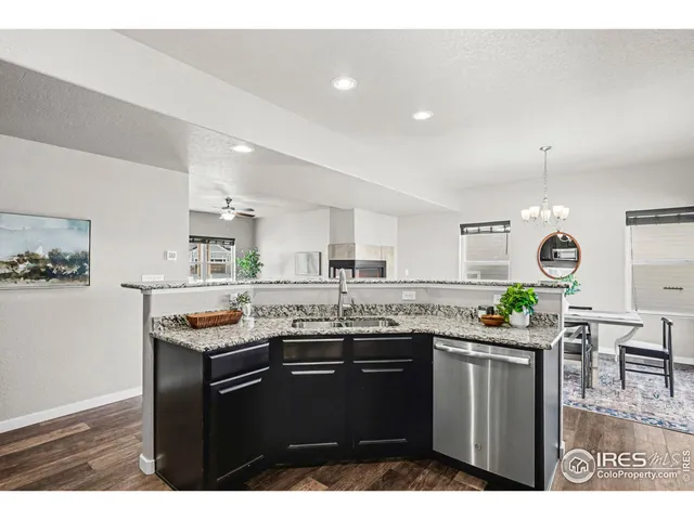 a kitchen with granite countertop a sink and a stove