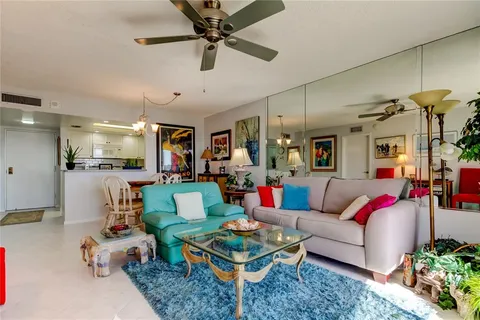 a living room with furniture and kitchen view