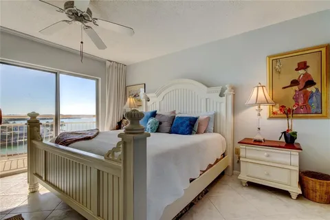 a bed room with bed and a chandelier