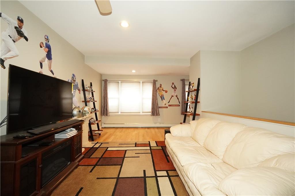 232 12th Street Brooklyn, NY 11215 - Photo 10 of 15 a living room with a flat screen tv and a couch