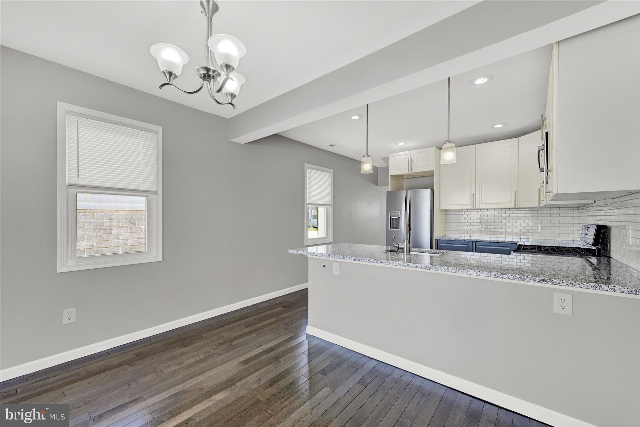 4604 Ridge Road Baltimore, MD 21236 - Photo 11 of 30 a large kitchen with granite countertop a large counter space and stainless steel appliances
