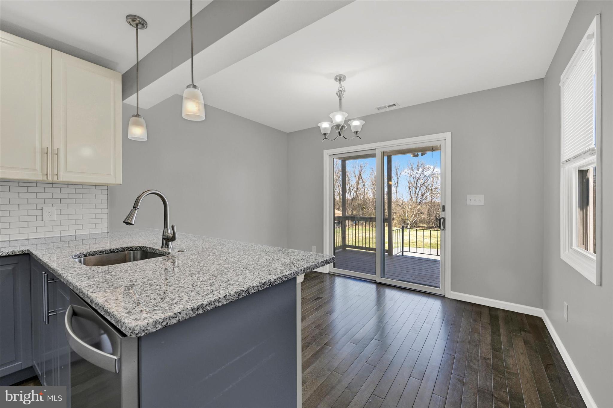 4604 Ridge Road Baltimore, MD 21236 - Photo 12 of 30 a view of granite countertop kitchen island with a sink and chandelier