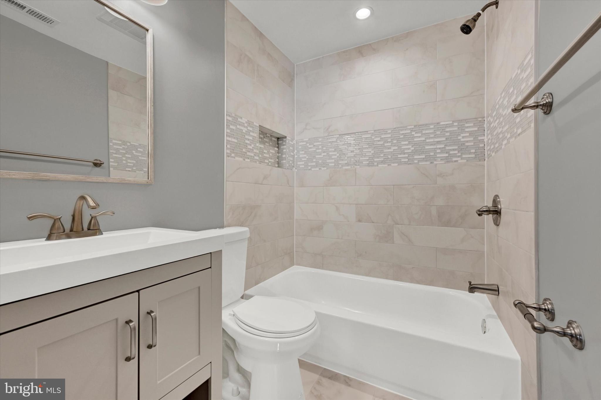 4604 Ridge Road Baltimore, MD 21236 - Photo 17 of 30 a bathroom with a sink a toilet and shower