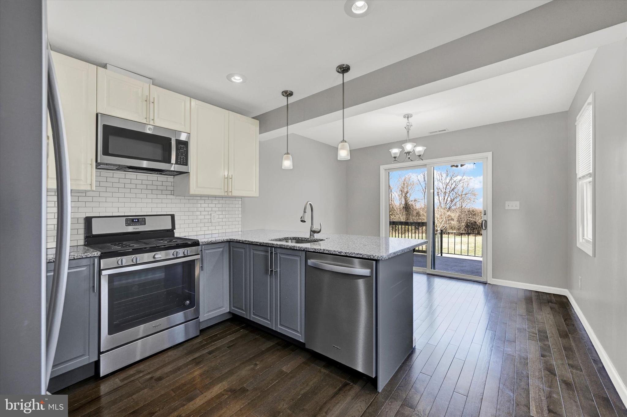 4604 Ridge Road Baltimore, MD 21236 - Photo 10 of 30 a kitchen with stainless steel appliances granite countertop a stove a sink and a microwave