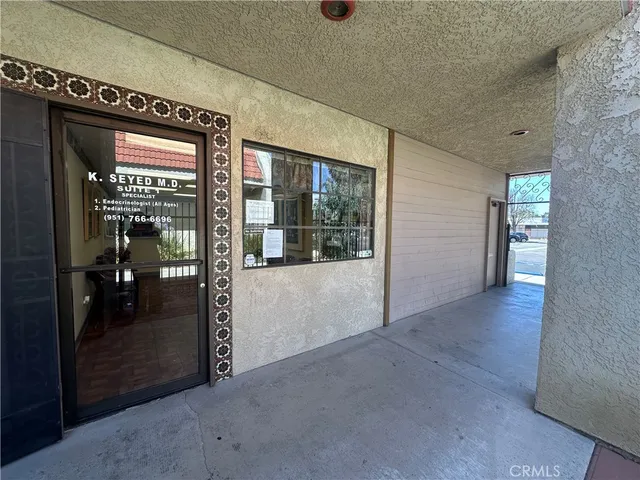 a view of a hallway with wooden shelves