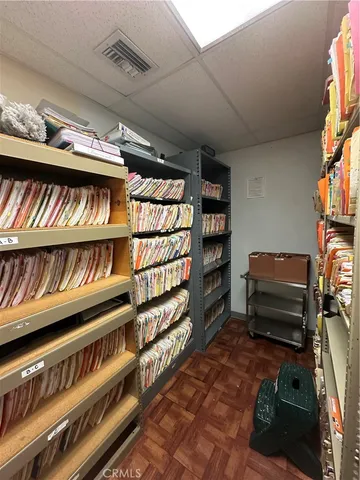 a living room with furniture gym equipment and a large window