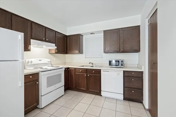 a kitchen with a stove top oven sink and cabinets