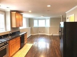 5 Shafter Street, Unit 1 Boston, MA 02121 - Photo 4 of 5 a view of a kitchen with wooden floor and electronic appliances