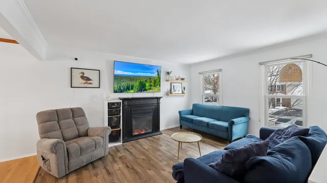 a living room with furniture a flat screen tv and a fireplace
