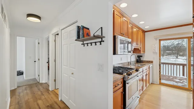 a kitchen with stainless steel appliances granite countertop a stove and a refrigerator