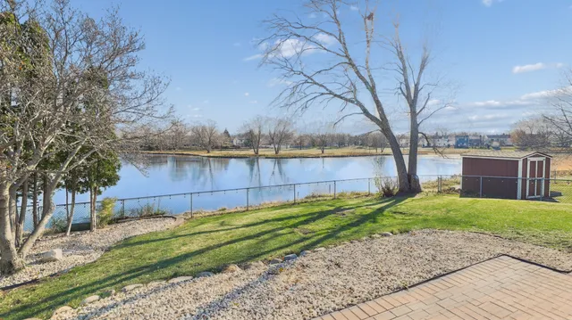 a view of backyard with wooden fence