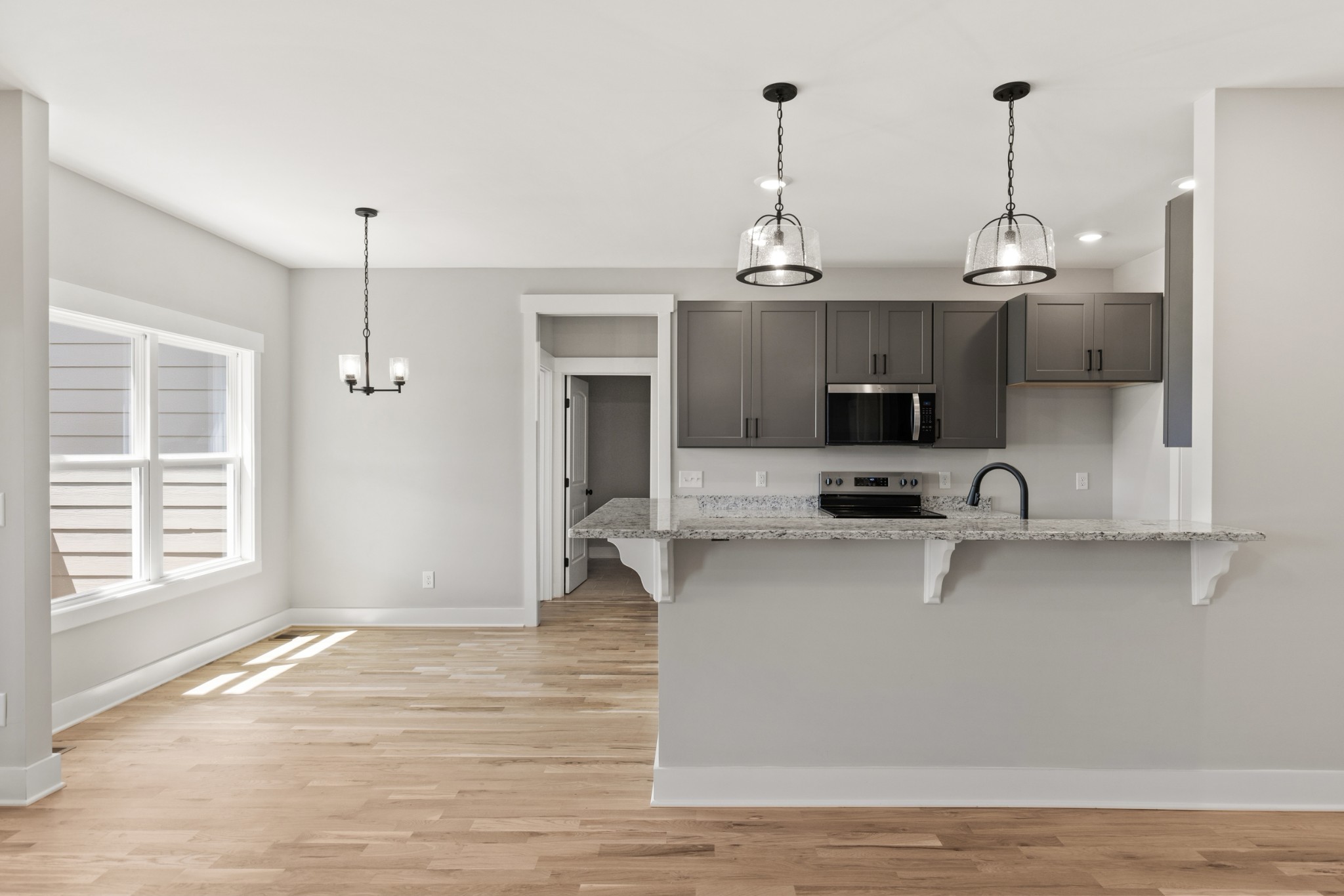 5638 Borthick Road Springfield, TN 37172 - Photo 11 of 43 a view of a kitchen with kitchen island a sink wooden floor and living room view