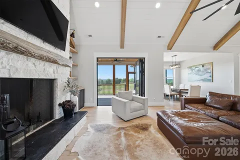 a living room with furniture and a floor to ceiling window