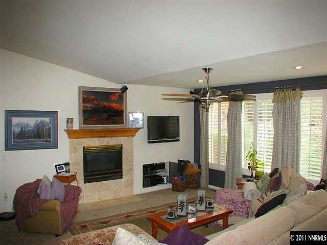 105 Gazelle Road Reno, NV 89511 - Photo 8 of 13 a living room with furniture a fireplace and a flat screen tv