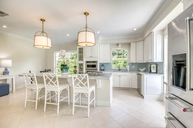 a view of a dining table chairs and chandelier