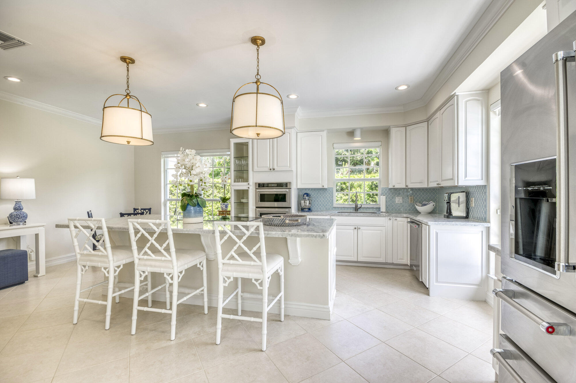 10182 Southeast Acorn Way Jupiter, FL 33469 - Photo 11 of 38 a view of a dining table chairs and chandelier